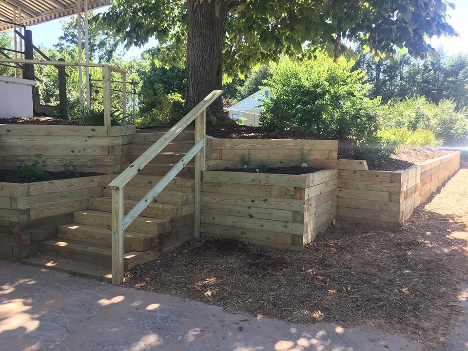 wooden-raised-bed-retaining-walls-with-stairs